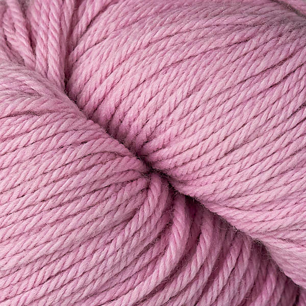 A close up of a skein of Berroco Vintage worsted weight yarn in light pink color