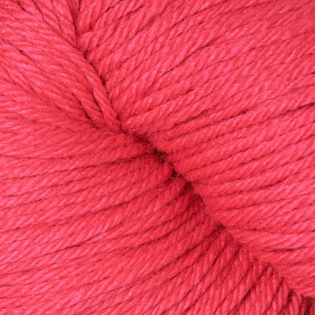 A close up of a skein of Berroco Vintage worsted weight yarn in bright salmon pink color