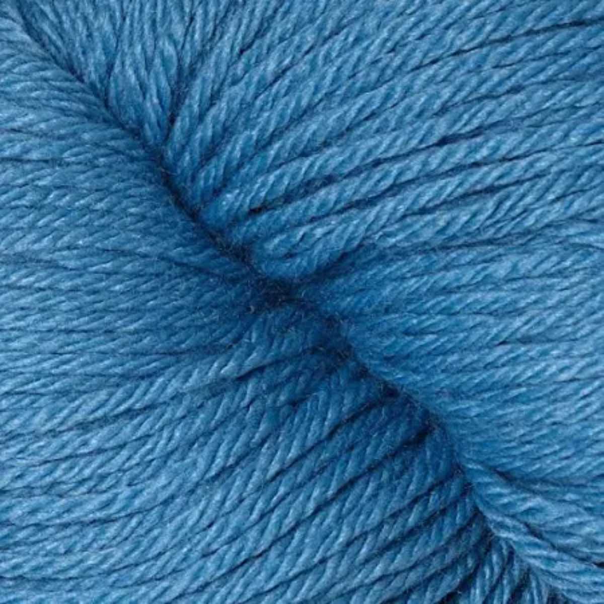 A close up of a skein of Berroco Vintage worsted weight yarn in blue color