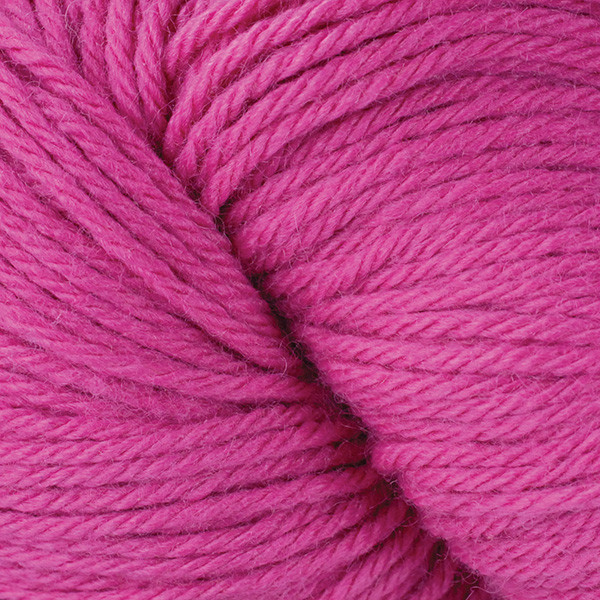 A close up of a skein of Berroco Vintage worsted weight yarn in magenta pink color