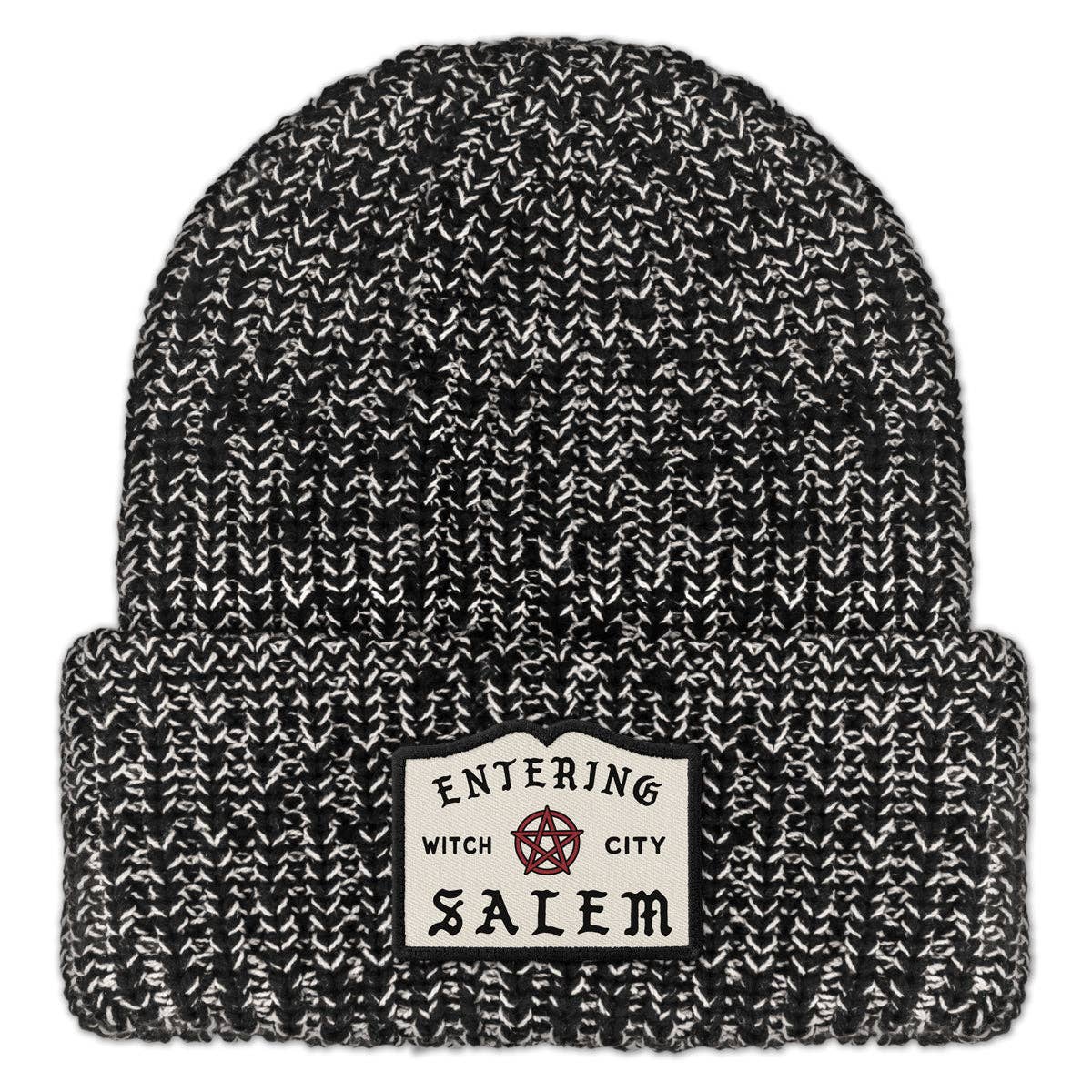 Black and white marled knit beanie with 'Entering Witch City Salem' embroidered patch on a white background