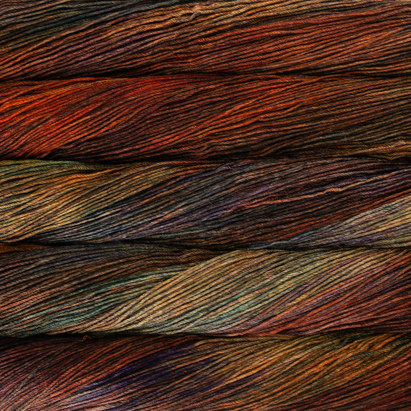 An image of skeins of Malabrigo Arroyo sport weight yarn in orange, yellow green, and brown shades.