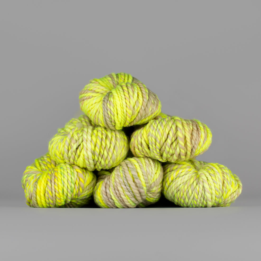 Skeins of Spincycle Plump Bulky weight yarn in yellow color gradient