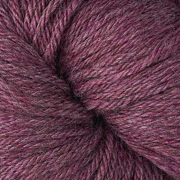 A close up of a skein of Berroco Vintage worsted weight yarn in heathered maroon red color
