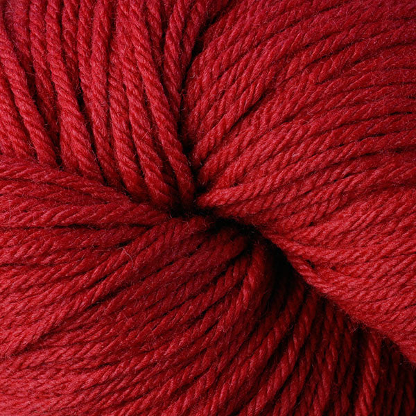 A close up of a skein of Berroco Vintage worsted weight yarn in deep earthy orange-red color