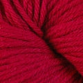 A close up of a skein of Berroco Vintage worsted weight yarn in red color