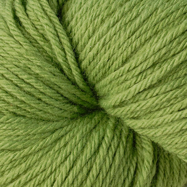 A close up of a skein of Berroco Vintage worsted weight yarn in dusty lime green color