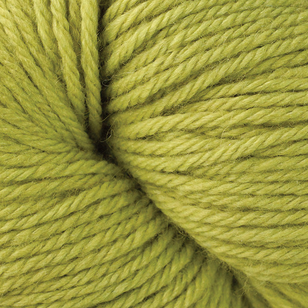 A close up of a skein of Berroco Vintage worsted weight yarn in mustard green color