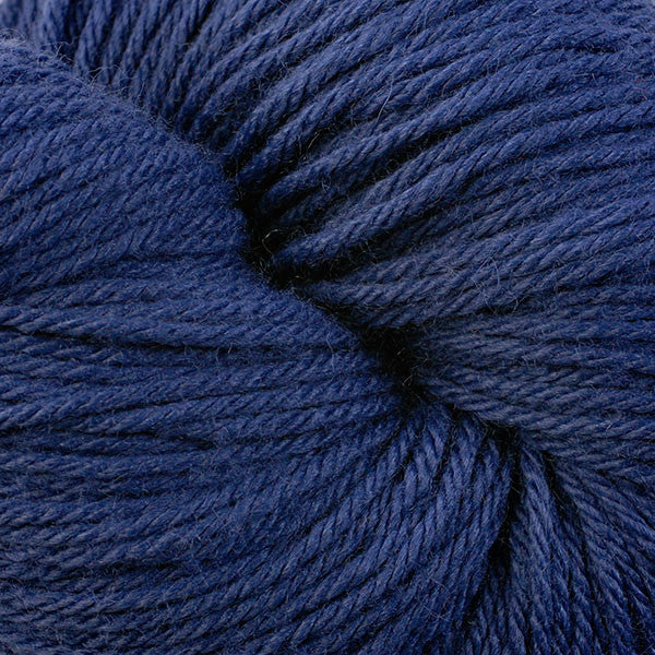 A close up of a skein of Berroco Vintage worsted weight yarn in deep blue color