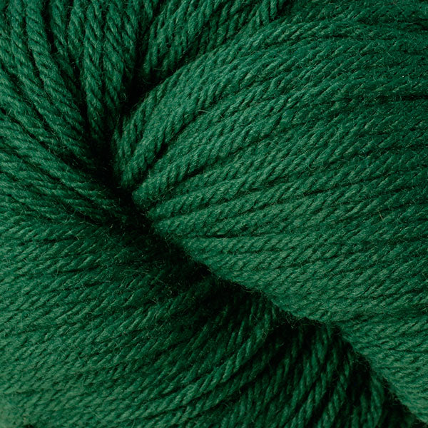 A close up of a skein of Berroco Vintage worsted weight yarn in deep green color