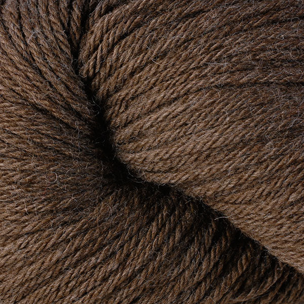 A close up of a skein of Berroco Vintage worsted weight yarn in brown color