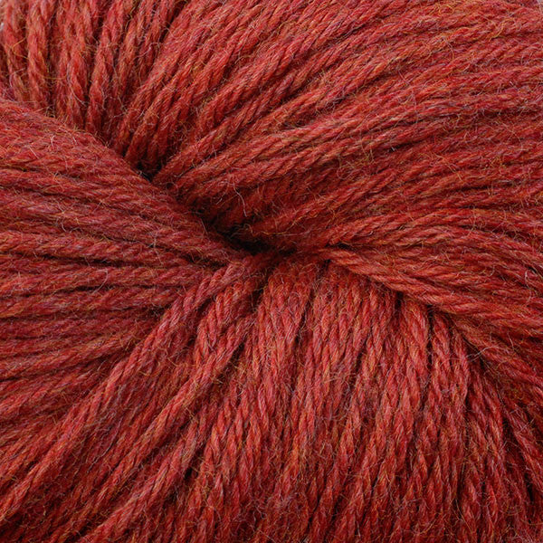 A close up of a skein of Berroco Vintage worsted weight yarn in dusty red-orange color