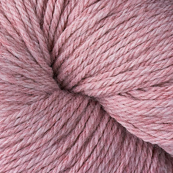 A close up of a skein of Berroco Vintage worsted weight yarn in light dusty pink rose color