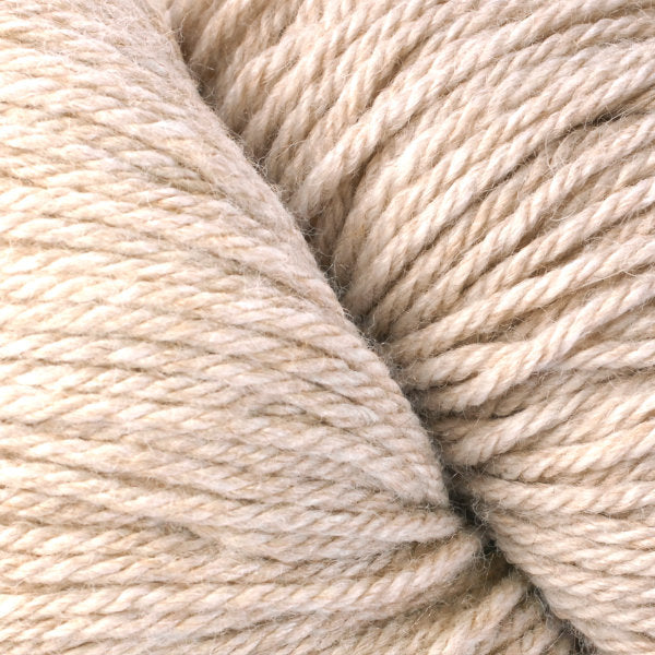 A close up of a skein of Berroco Vintage worsted weight yarn in light beige color