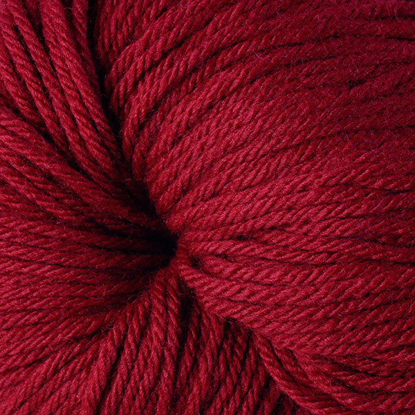 A close up of a skein of Berroco Vintage worsted weight yarn in deep red coloe
