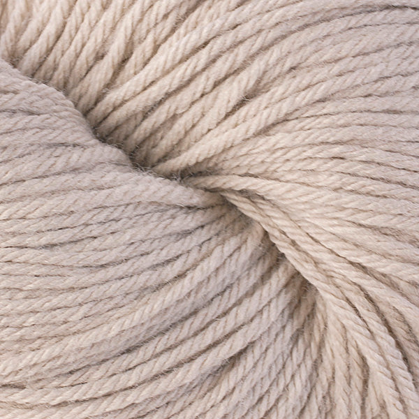 A close up of a skein of Berroco Vintage worsted weight yarn in light pale beige color