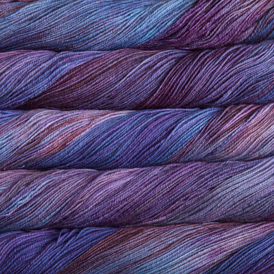 A close-up image of skeins of Malabrigo Sock yarn in shades of blue and purple.
