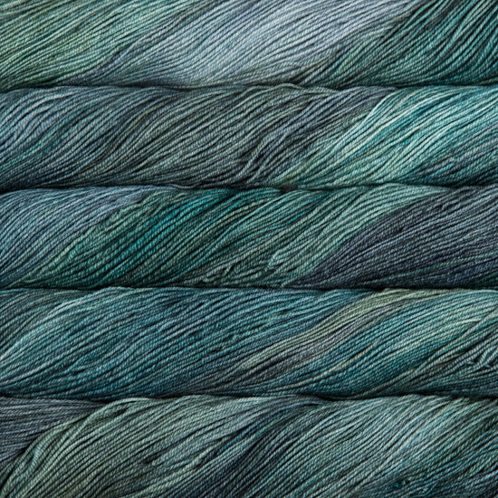 A close-up image of skeins of Malabrigo Sock yarn in shades of blue and green.