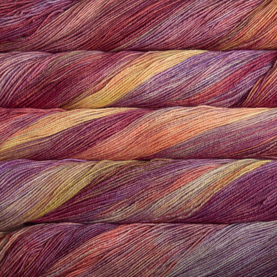 A close-up image of skeins of Malabrigo Sock yarn in shades of orange, pink, and yellow.