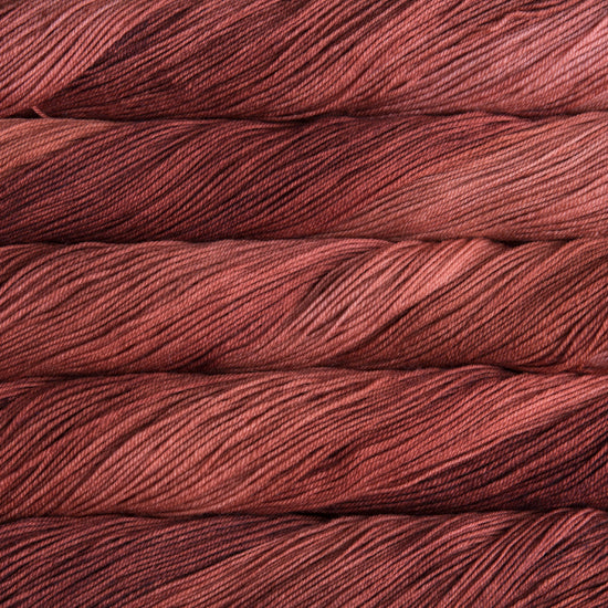 A close-up image of skeins of Malabrigo Sock yarn in shades of red.