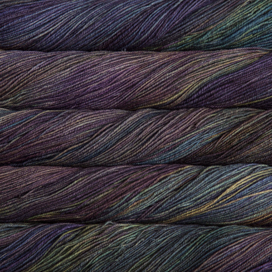 A close-up image of skeins of Malabrigo Sock yarn in cool shades of blue, green, and purple.