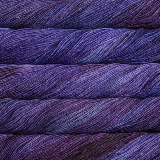 A close-up image of skeins of Malabrigo Sock yarn in shades of purple.