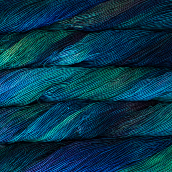A close-up image of skeins of Malabrigo Sock yarn in aqua, green, and navy colors.