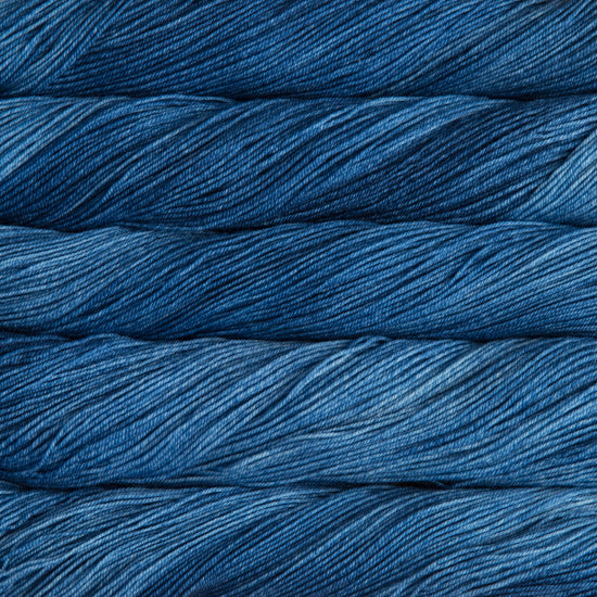 A close-up image of skeins of Malabrigo Sock yarn in ocean blue shades.
