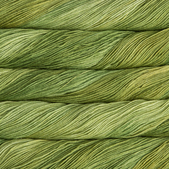 A close-up image of skeins of Malabrigo Sock yarn in bright green shades.
