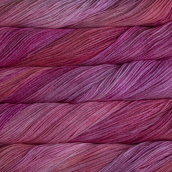 A close-up image of skeins of Malabrigo Sock yarn in bright pink shades.