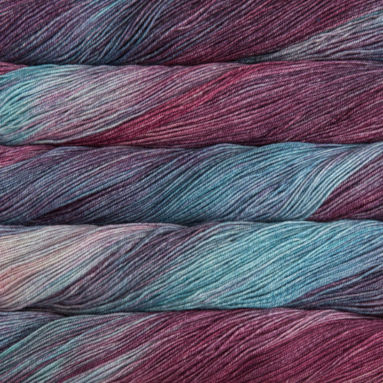 A close-up image of skeins of Malabrigo Sock yarn in sky blue and berry colors.