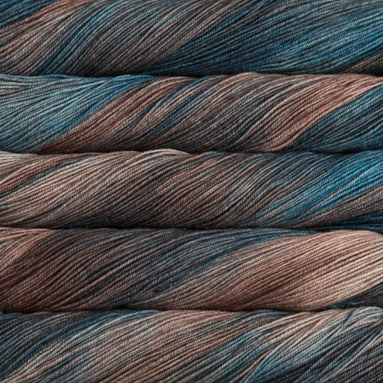 A close-up image of skeins of Malabrigo Sock yarn in shades of blue and brown.