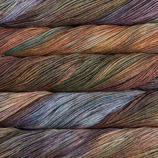 A close-up image of skeins of Malabrigo Sock yarn in brown, green, orange, and purple.
