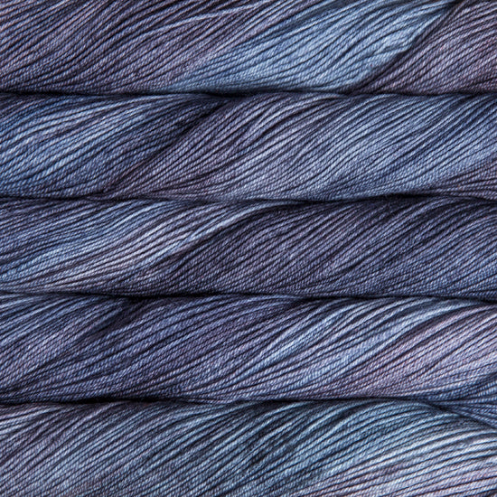 A close-up image of skeins of Malabrigo Sock yarn in shades of purple and gray blue.