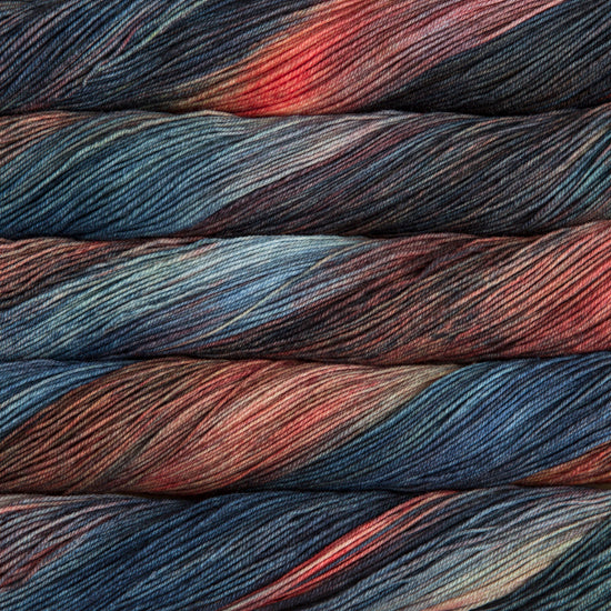 A close-up image of skeins of Malabrigo Sock yarn in brown, orange, and blue shades.