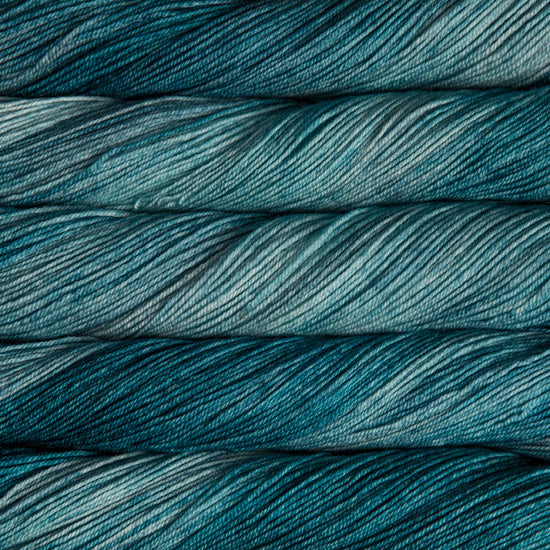 A close-up image of skeins of Malabrigo Sock yarn in shades of teal.
