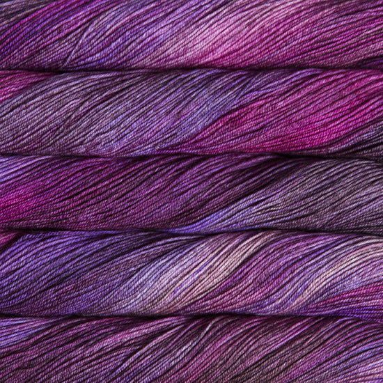 A close-up image of skeins of Malabrigo Sock yarn in shades of purple.