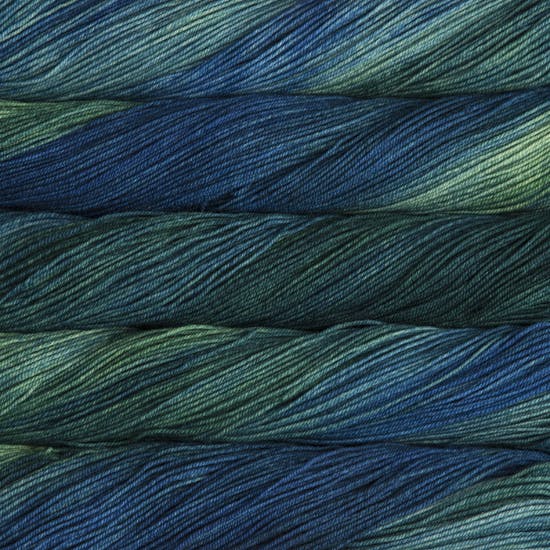 A close-up image of skeins of Malabrigo Sock yarn in deep blue and green shades.