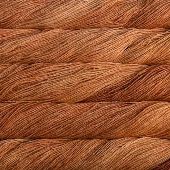 A close-up image of skeins of Malabrigo Sock yarn in shades of orange.