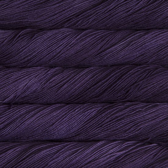 A close-up image of skeins of Malabrigo Sock yarn in dark purple.