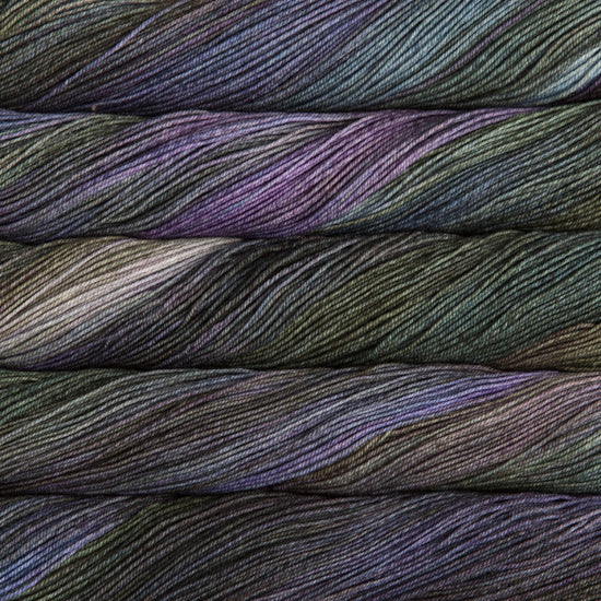 A close-up image of skeins of Malabrigo Sock yarn in blue, green, and purple shades.