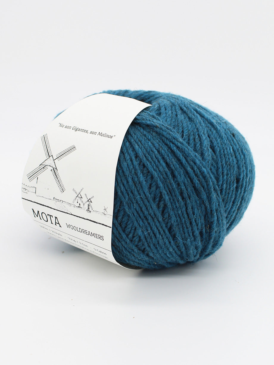 A skein of denim blue yarn on a white background.