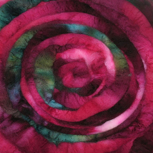 A close up of Frabjous Fibers BFL Spinning Fiber in dark pink and green colors
