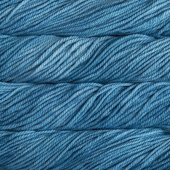 A close up image of skeins of Malabrigo Chunky bulky weight yarn in ocean blue shades.