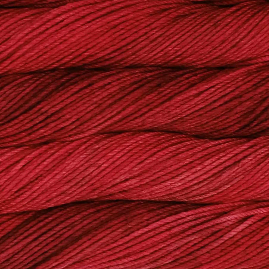 A close up image of skeins of Malabrigo Chunky bulky weight yarn in shades of deep red.