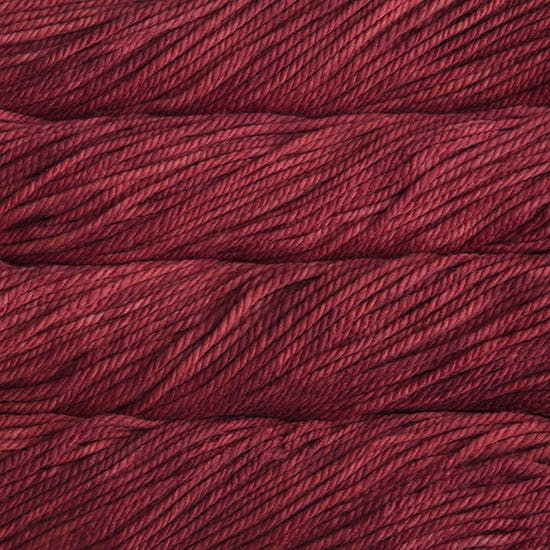 A close up image of skeins of Malabrigo Chunky bulky weight yarn in deep rich shades.