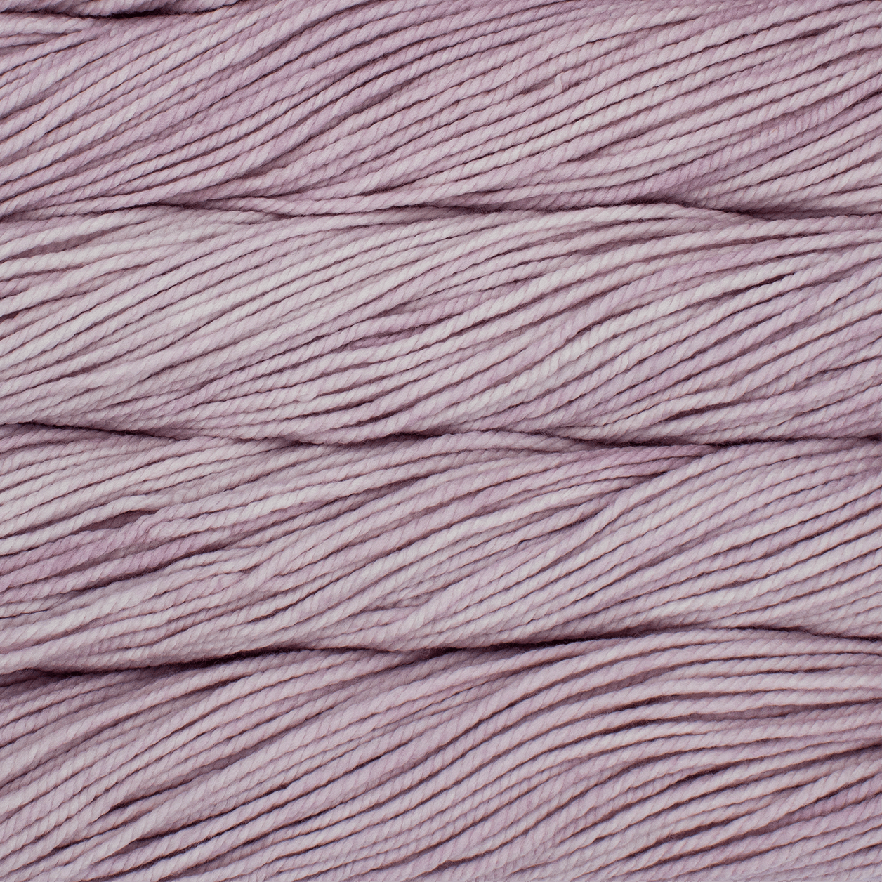 A close up image of skeins of Malabrigo Chunky bulky weight yarn in shades of pale pink.