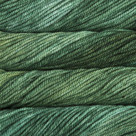 A close up image of skeins of Malabrigo Chunky bulky weight yarn in sea green and forest green shades.
