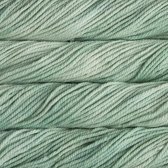 A close up image of skeins of Malabrigo Chunky bulky weight yarn in pale mint green shades.