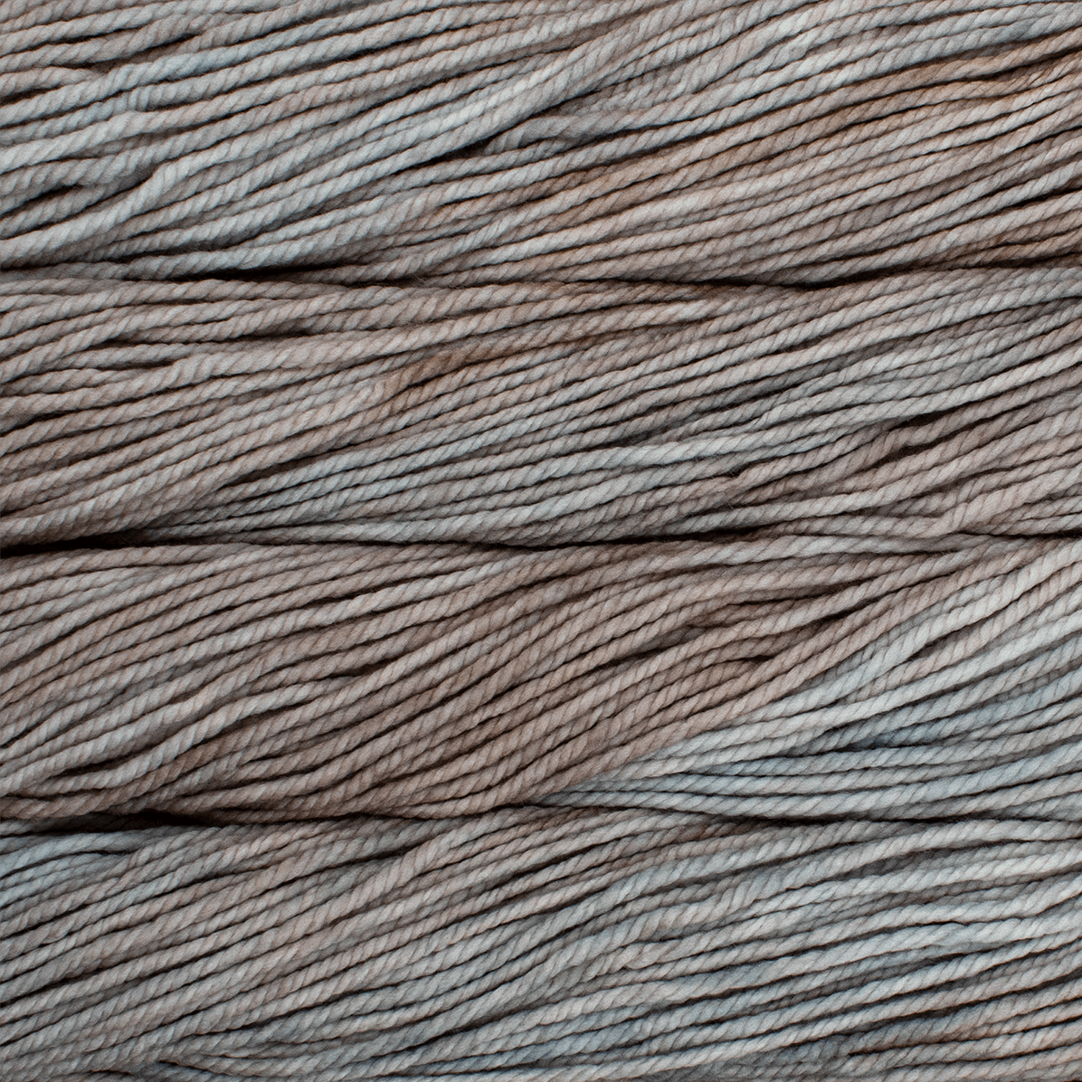A close up image of skeins of Malabrigo Chunky bulky weight yarn in light brown and taupe shades.